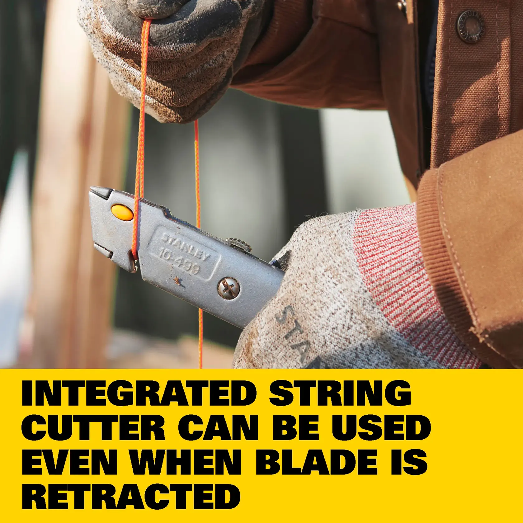 Close-up image of a STANLEY 10-499 utility knife with a quick release blade change mechanism, placed on a wooden surface.