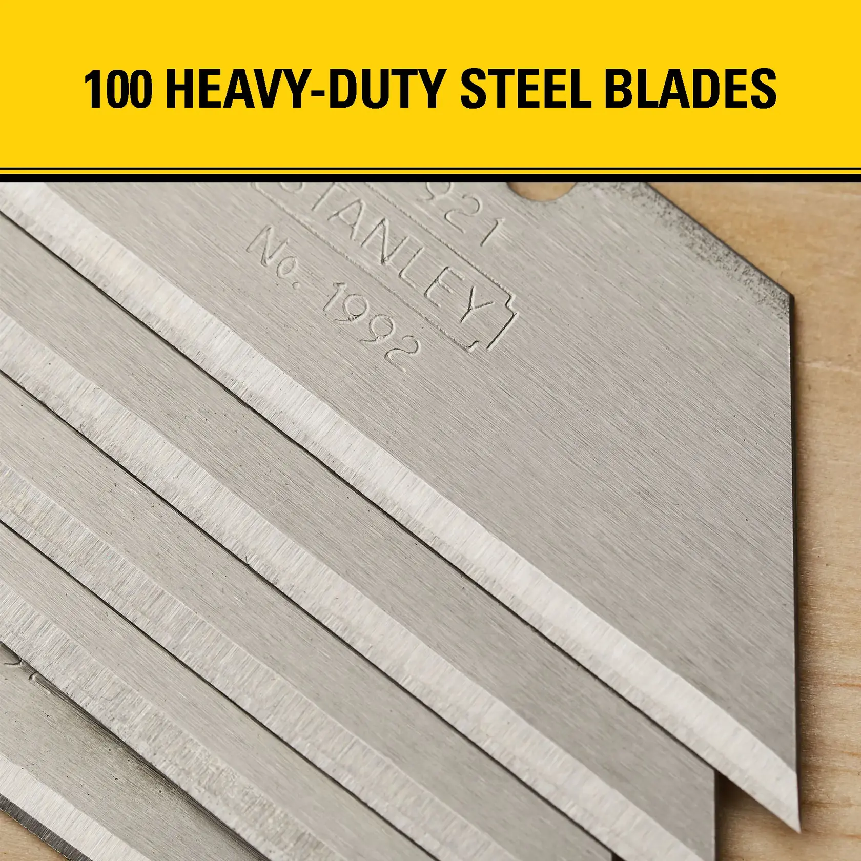 Close-up of several heavy-duty steel utility blades stacked together, with text above stating '100 heavy-duty steel blades'.