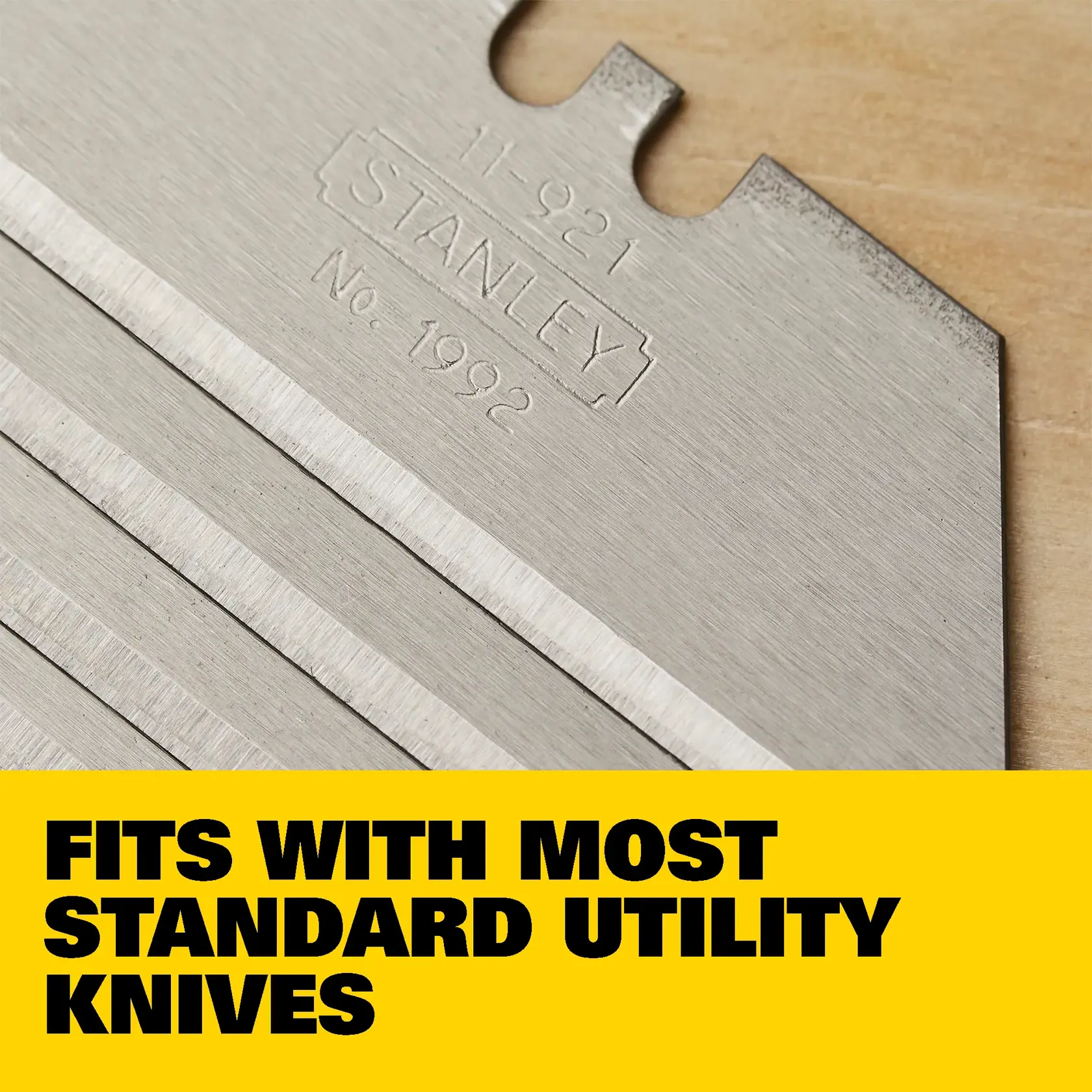 Image showing a Stanley utility knife blade with labeled features: precision honed edge, utility knife compatible, heavy-duty steel, and includes 5 all-purpose blades. A 'Made in USA' label is present in the lower left corner.
