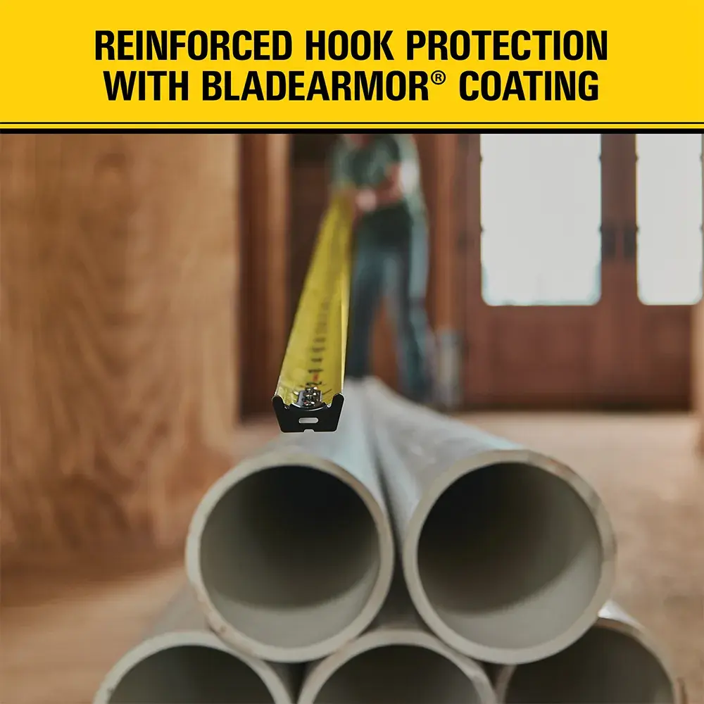A close-up of a yellow tape measure extended over stacked pipes, with the text 'Reinforced Hook Protection with BladeArmor Coating' above. The image promotes the durability feature of the measuring tape.