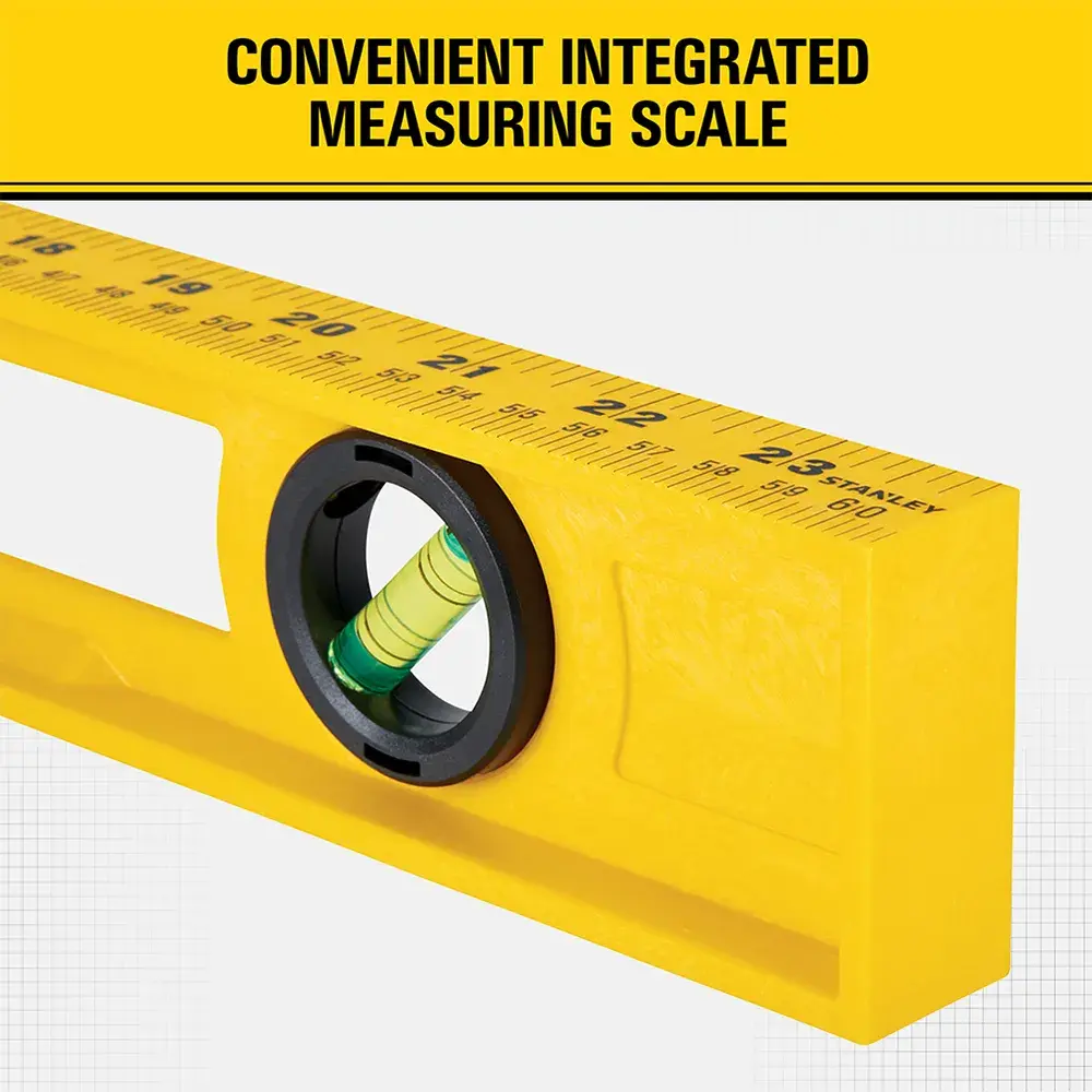 Close-up image of a yellow Stanley spirit level with an integrated measuring scale printed along the top edge. The level features a bubble vial for precise measurement.