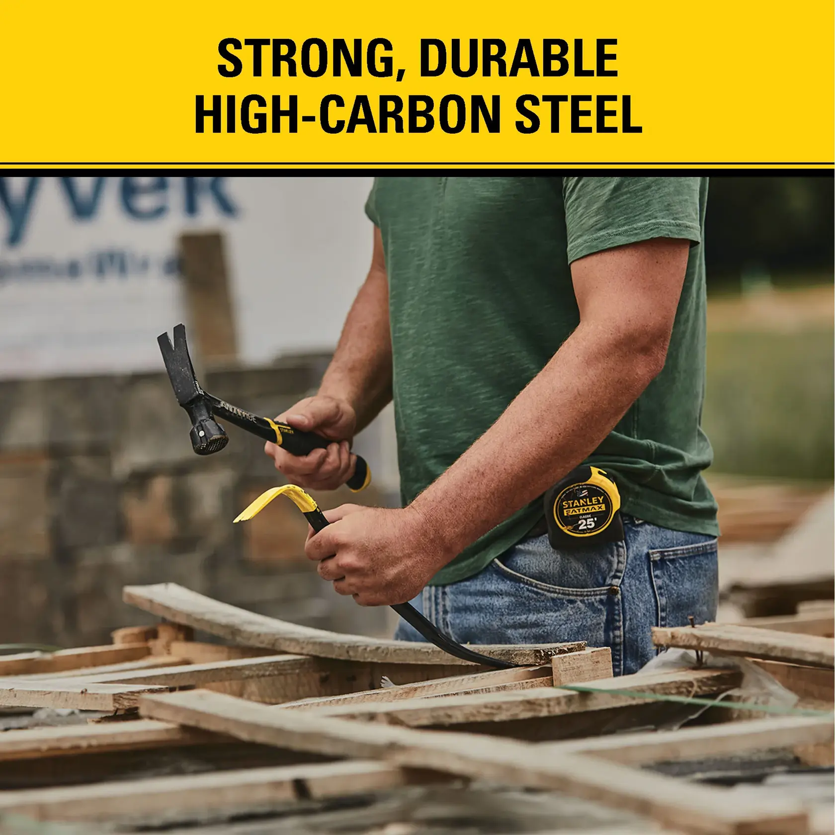 A person in a green shirt and jeans is working outdoors with wood, holding a STANLEY crowbar and hammer. A yellow STANLEY tape measure is clipped to their jeans. The image features a bold yellow banner that reads, 'Strong, Durable High-Carbon Steel.'