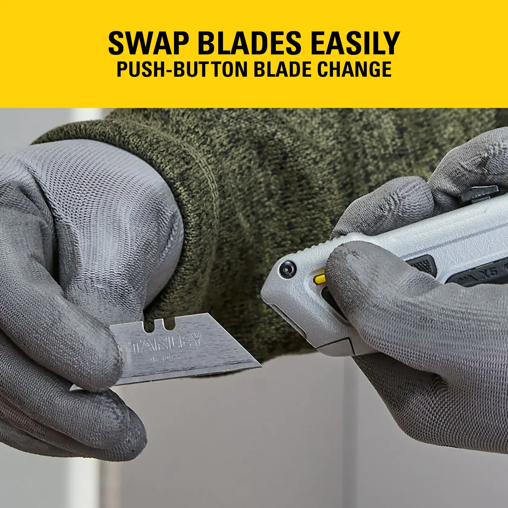 Gloved hands changing a Stanley utility knife blade using push-button release. Yellow swap blades easily banner shown.