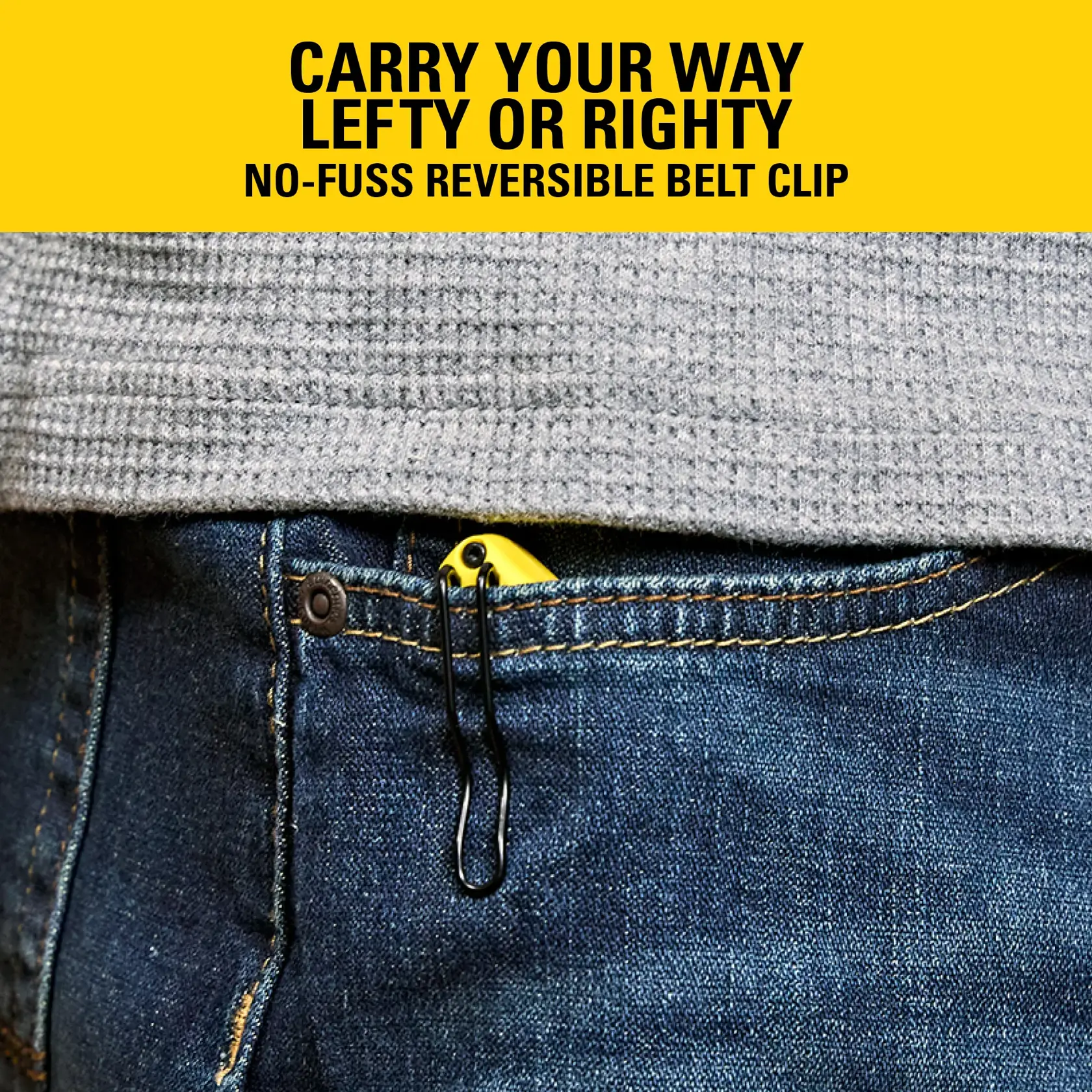 Stanley knife with reversible belt clip partially visible in front pocket of blue jeans, under gray shirt.