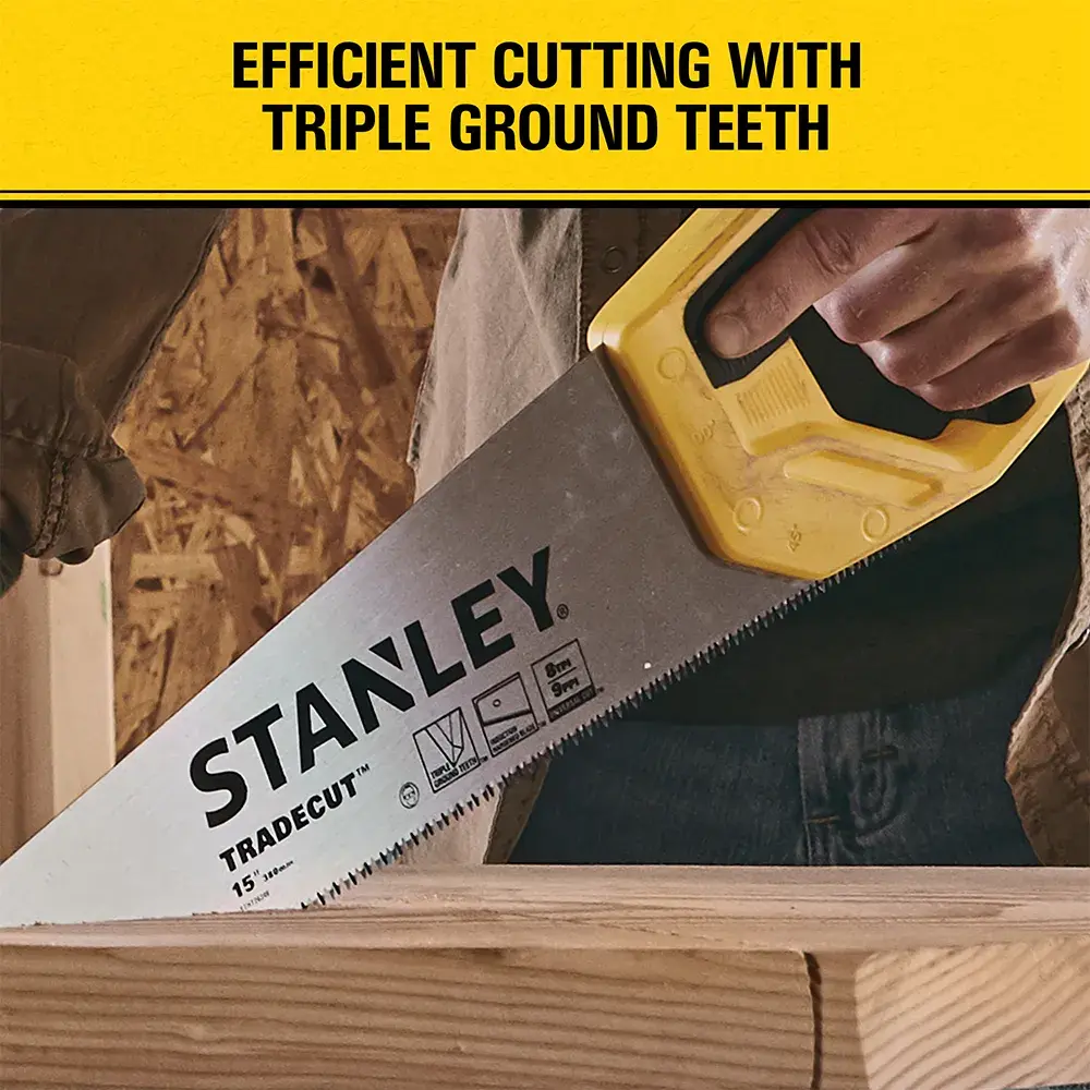 A hand holding a Stanley Tradecut handsaw with a yellow handle, cutting through a piece of wood. The saw blade has text on it, and above the image is a yellow banner with the words 'Efficient cutting with triple ground teeth.'