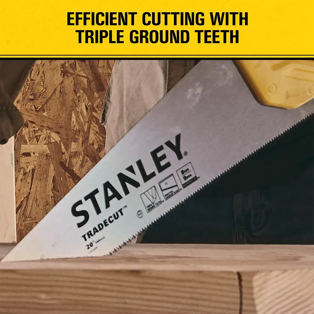 A STANLEY Tradecut hand saw with a yellow handle is cutting through a piece of wood. The saw blade displays the brand name and features icons. A yellow banner above the saw reads: 'Efficient cutting with triple ground teeth.' Background includes wooden panels and tools.