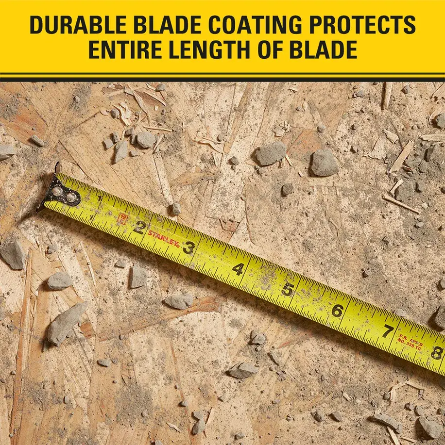 A yellow STANLEY tape measure extended over a wooden surface with debris. The image emphasizes the durable blade coating that protects the entire length of the blade, as stated in the text at the top.