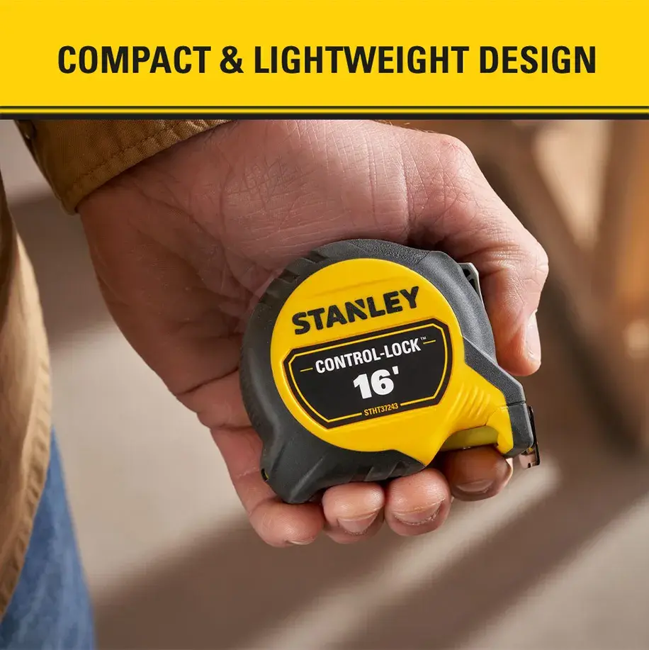A hand holding a Stanley Control-Lock 16-foot tape measure, highlighting its compact and lightweight design.