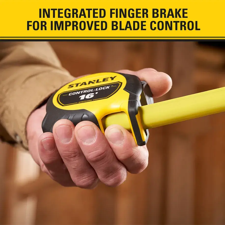 A close-up of a hand holding a STANLEY tape measure with a yellow blade. The text above reads 'Integrated finger brake for improved blade control.'