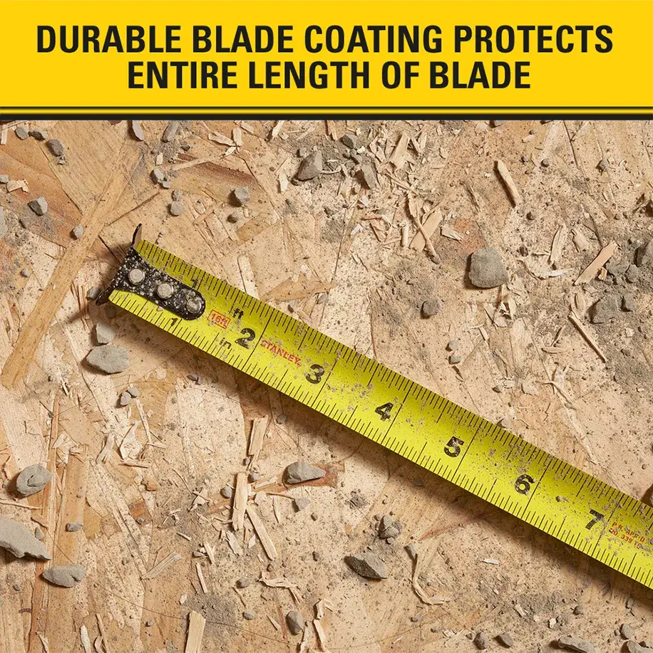 A yellow measuring tape with black markings lies on a wooden surface with debris. The image highlights that the durable blade coating protects the entire length of the tape blade.