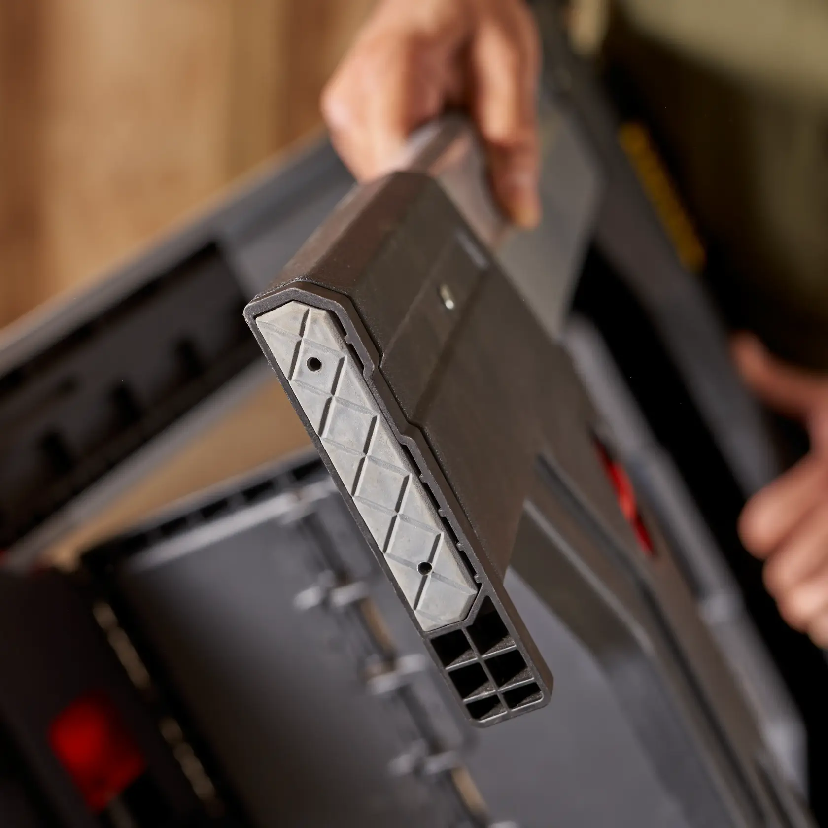 STANLEY 011031S toolbox corner close-up showing reinforced plastic edge, person holding it, photography.