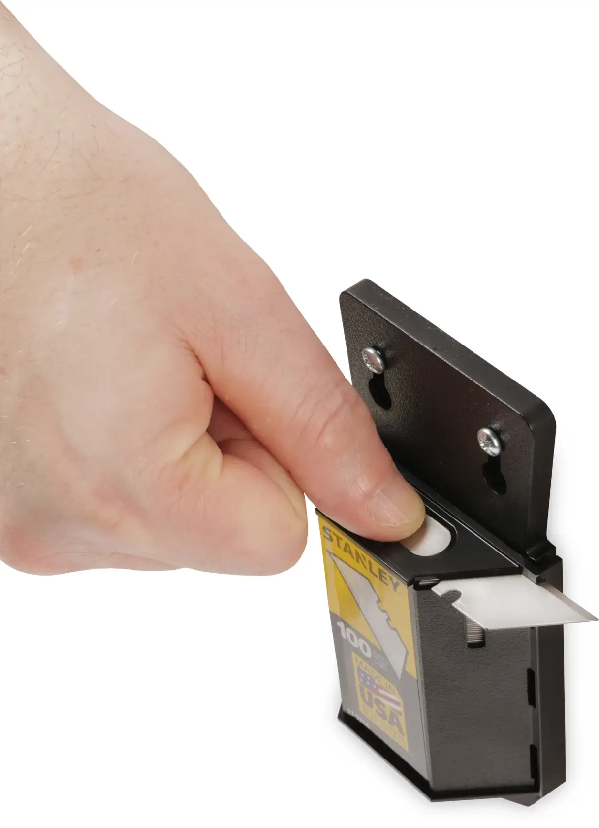 STANLEY 11-921A utility blade dispenser with hand extracting a blade, close-up on white background.