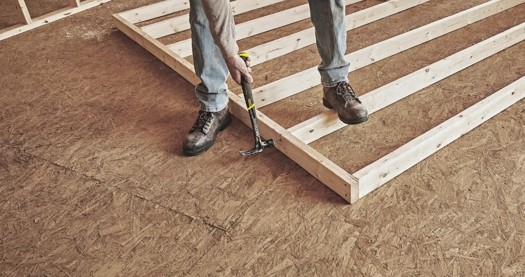 STANLEY 51-167 hammer used to nail wooden frame on plywood floor, photo of construction work.