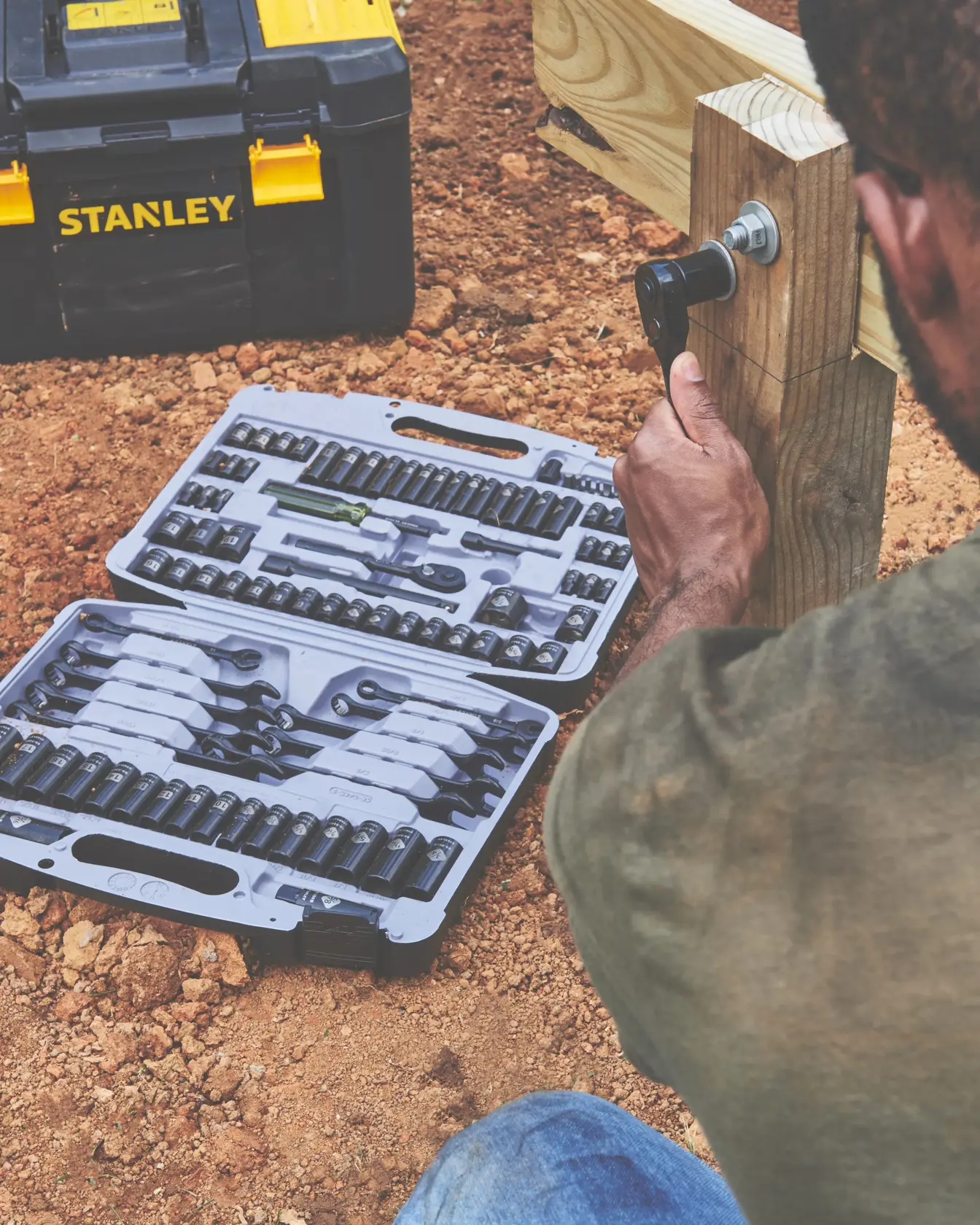 STANLEY 92-839 socket wrench set in open case beside toolbox, used outdoors on construction site.