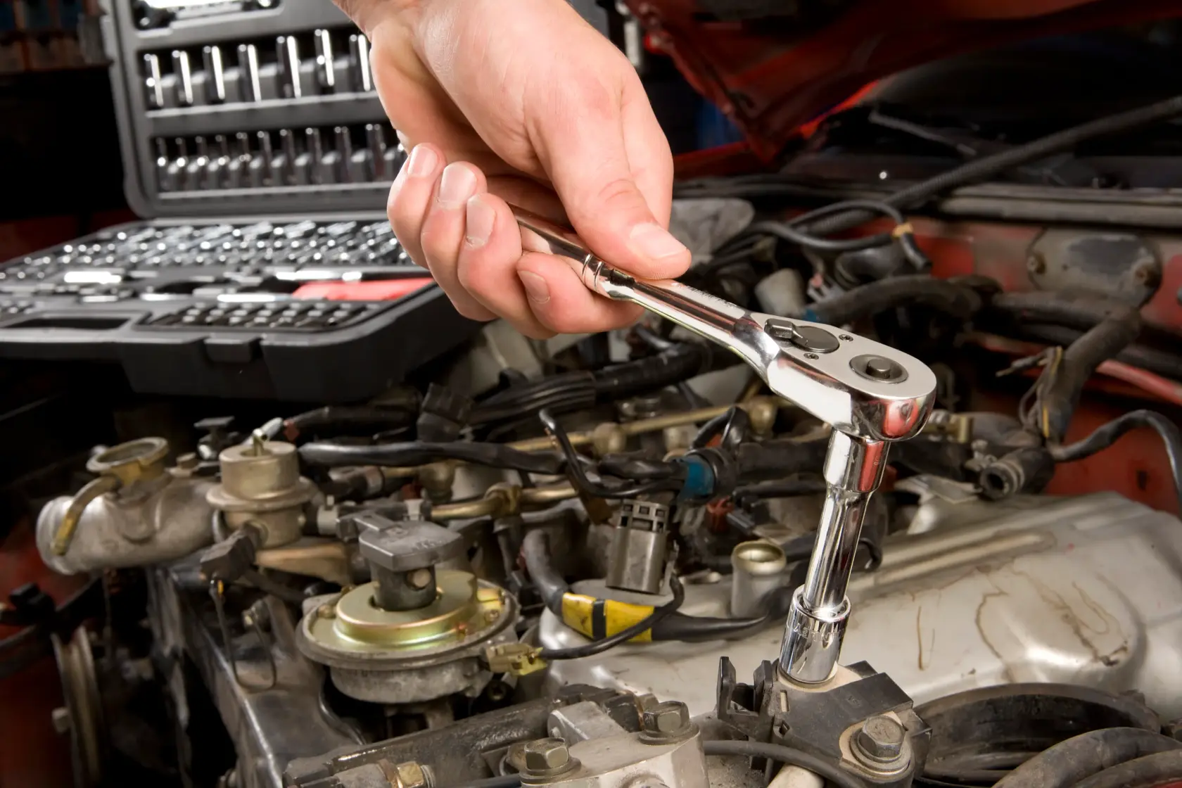 STANLEY STMT71654 socket wrench in use, automotive repair scene, tool kit visible in background.