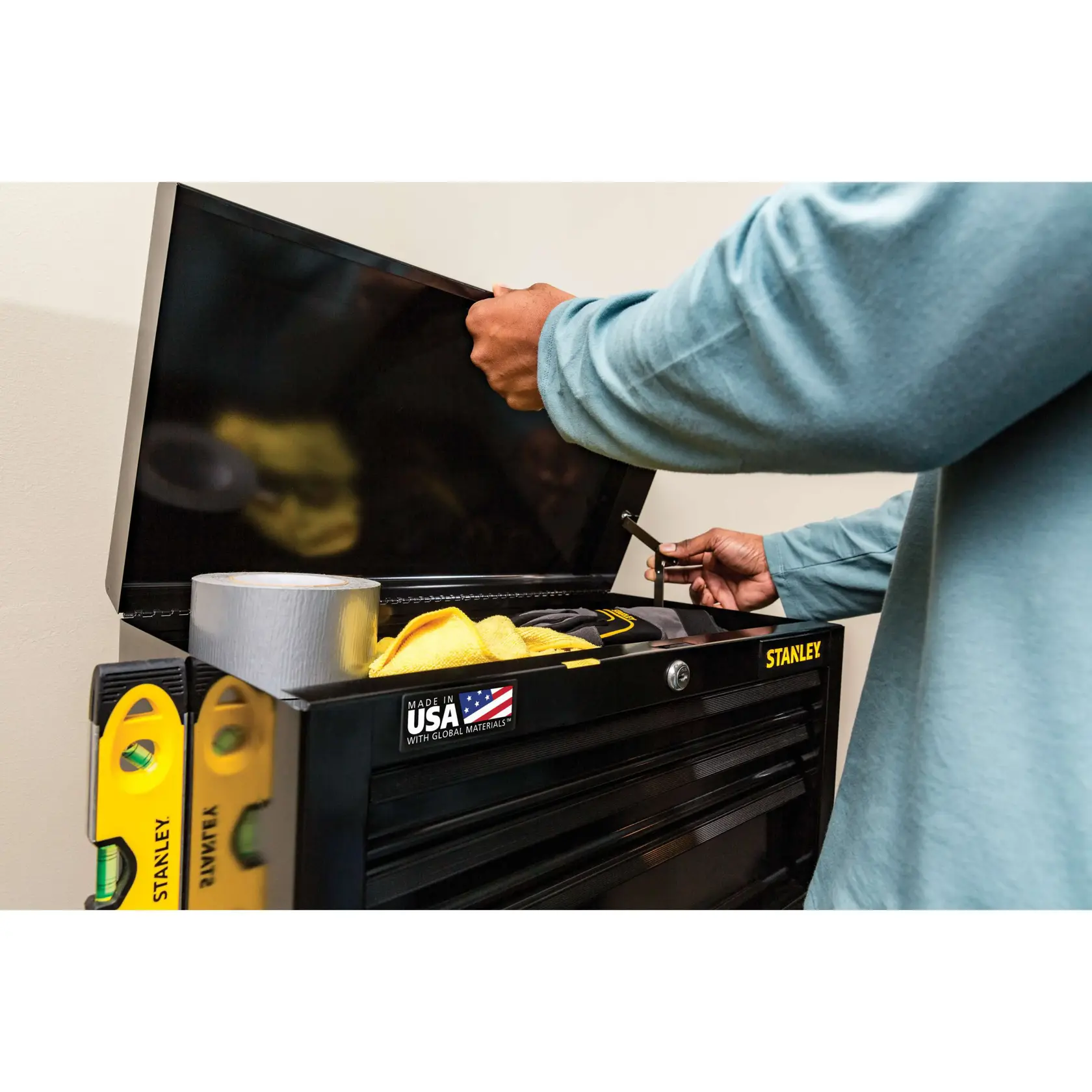 STANLEY STST22656BK tool chest with open lid, showing tape, level, and cleaning cloths, side angle photo.