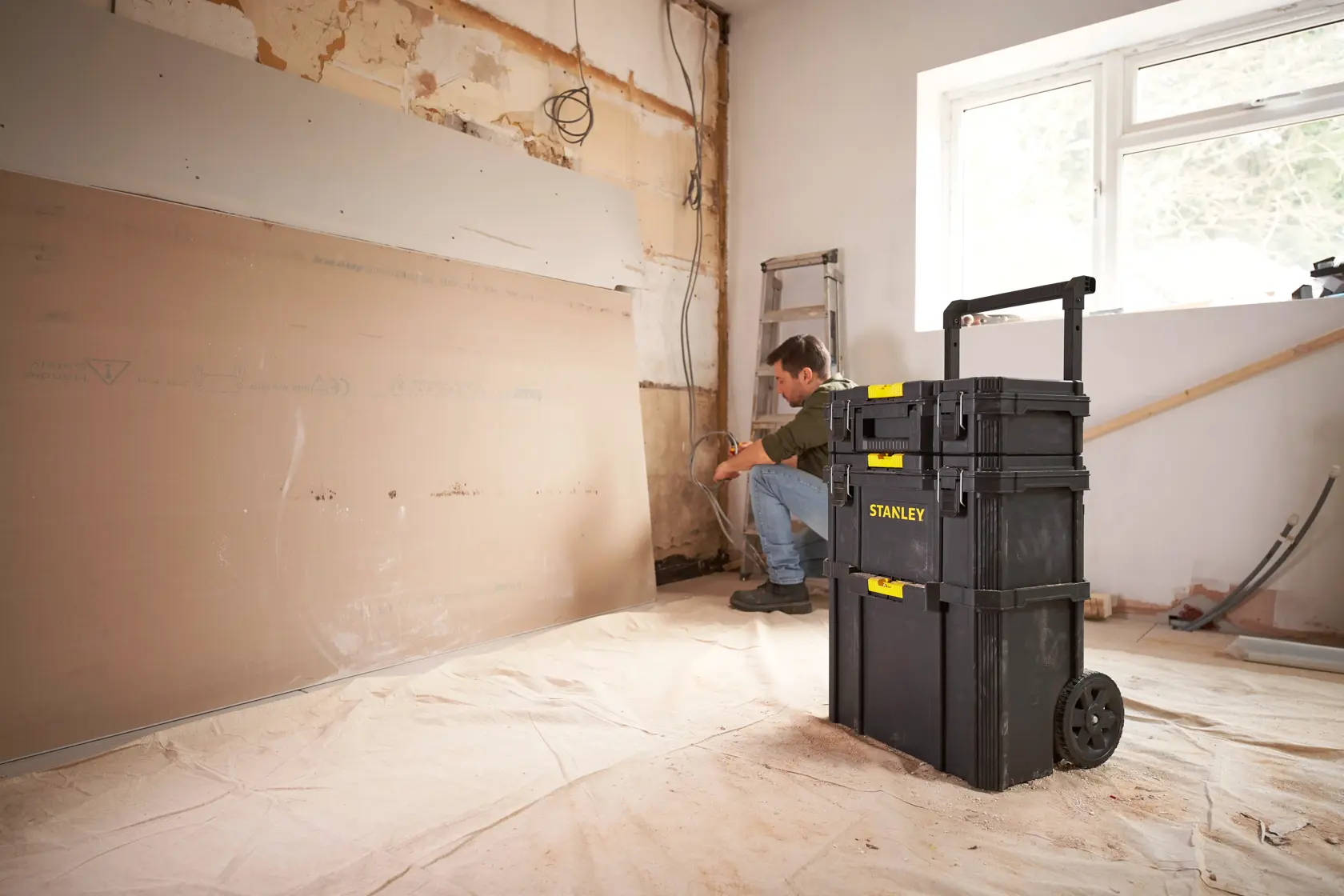 STANLEY STST60500 rolling tool chest in a renovation room, shown from a front angle.